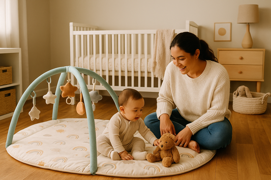 A mother and baby playing together on a soft activity mat in a warm, cozy nursery setting.
