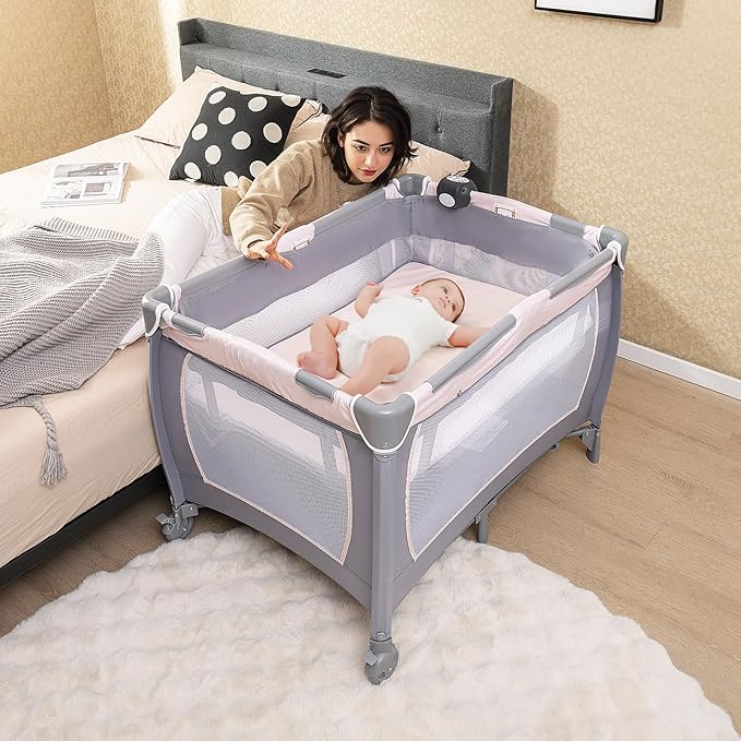 HONEY JOY Pack and Play with Bassinet, Infant Nursery Center Pack and Play w/Newborn Cradle & Hanging Toys, Diaper Storage, Music, Portable Baby Playard w/Changing Station (Starry Pink)